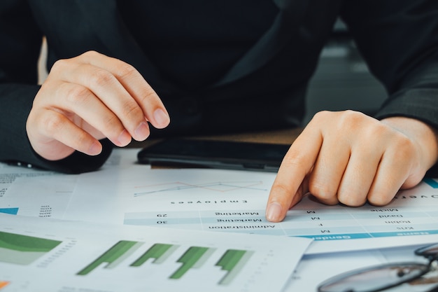 Close up hand of accountant checking data on documents