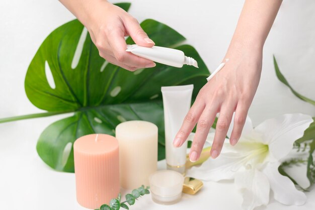 A close up hand of applying moisturizing cream skincare and beauty concept