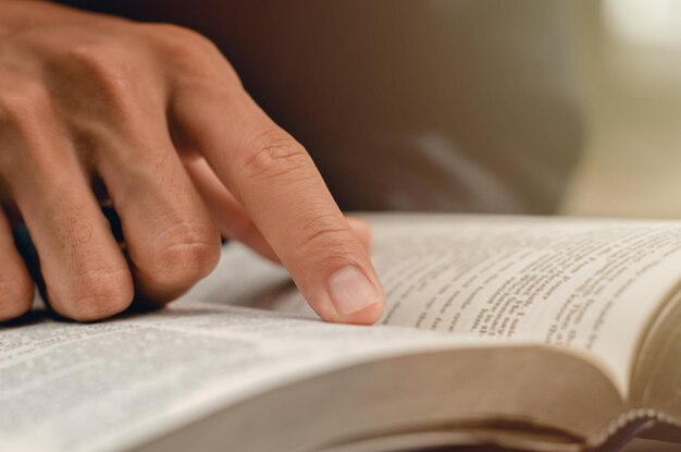 Close-up of hand on book