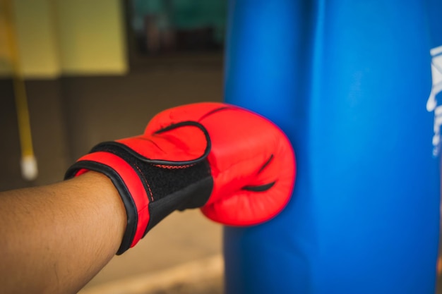 Close-up of hand boxing punching bag