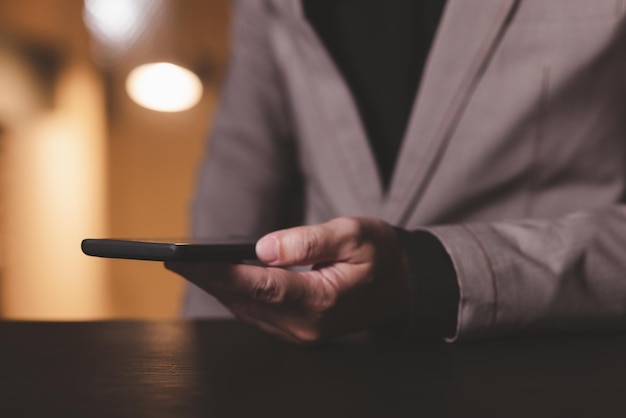 Close up hand of businessman with mobile phone Concept of technoloy for business