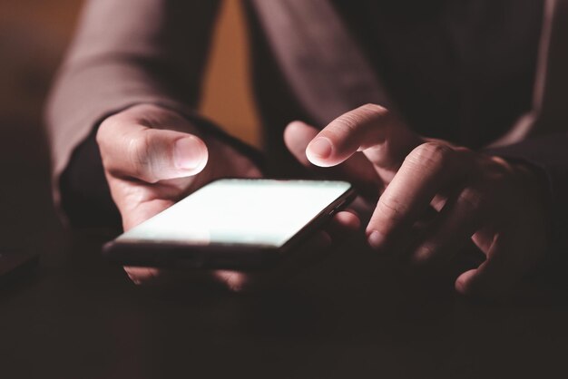 Close up hand of businessman with mobile phone Concept of technoloy for business