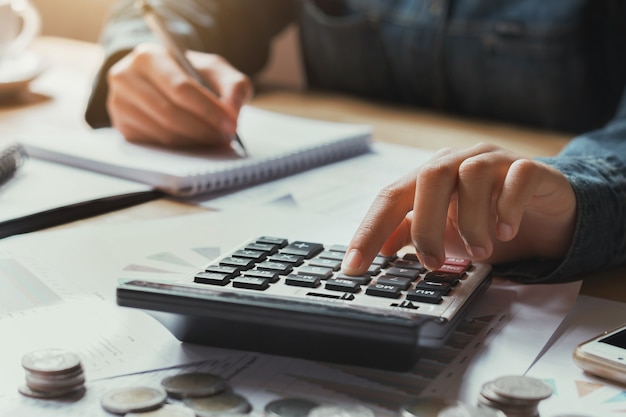 Close up hand businesswoman using calculator for calculate finance accounting in office