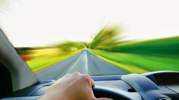 Photo close-up of hand on car against sky