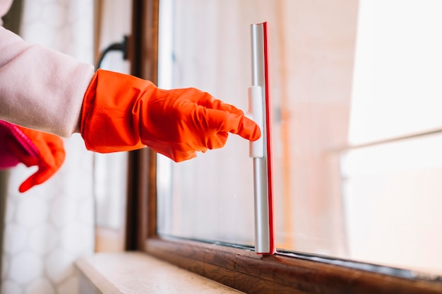 Close-up hand cleaning window