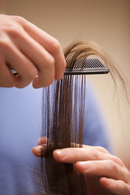 Close up of a hand combing hair