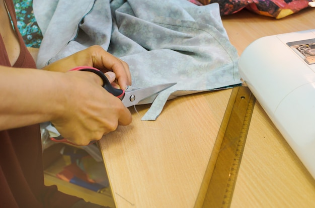 Close-up of a hand cut a cloth flap