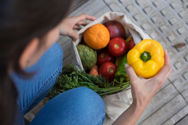 Close up hand holding bell pepper