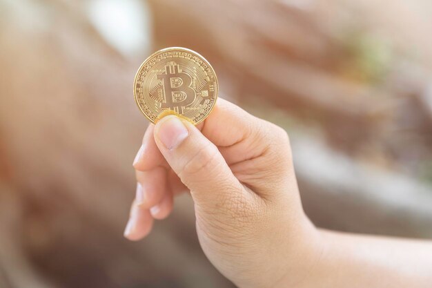 Close-up of hand holding bitcoin