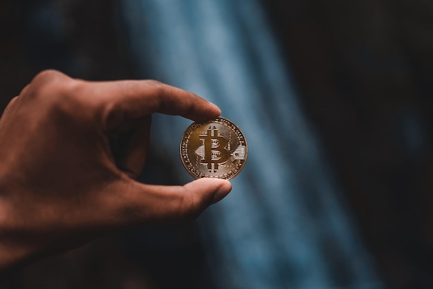 close-up of hand holding bitcoin