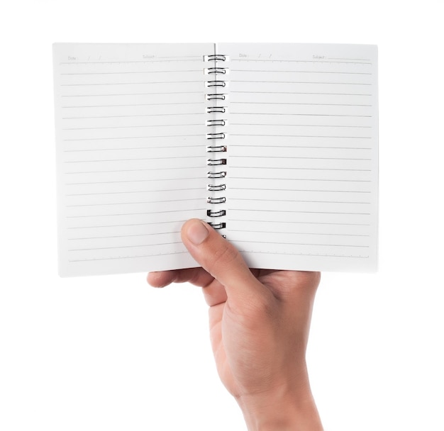 Close-up of hand holding blank book against white background