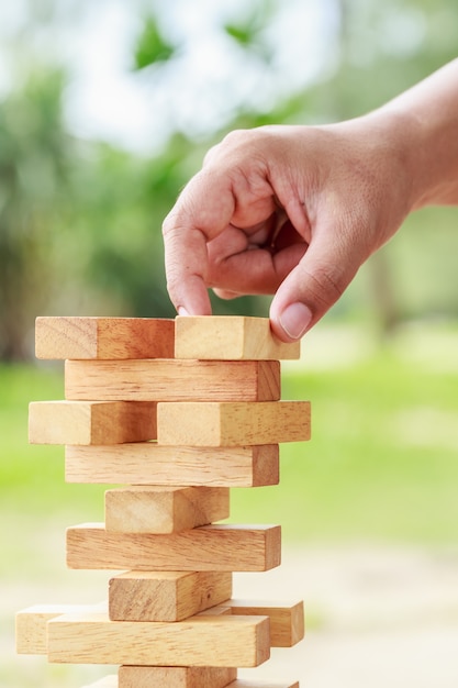 Close up hand holding blocks wood game