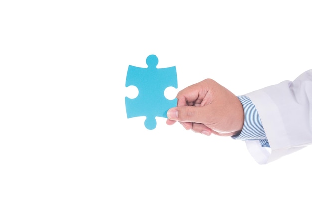 Close-up of hand holding blue puzzle