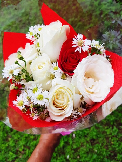 Close-up of hand holding bouquet