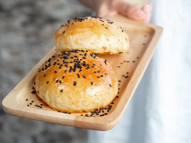 Photo close-up of hand holding bread in plate