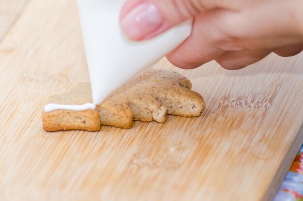 Close-up of hand holding bread on table