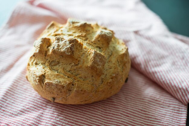 Close-up of hand holding bread on table