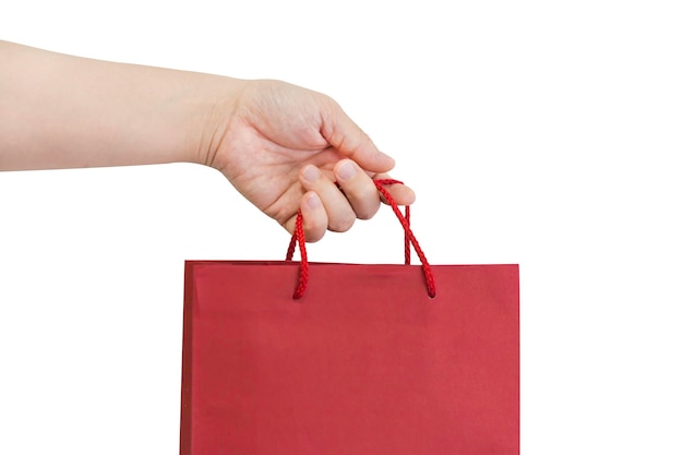 Photo close-up of hand holding brown bag against white background