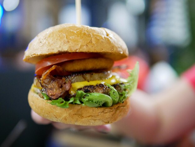 Close-up of hand holding burger