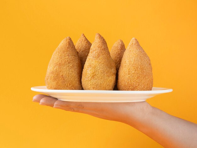 Photo close-up hand holding chicken croquettes