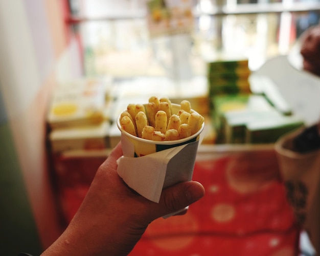 Close-up of hand holding chips