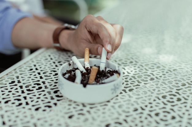 Close-up of hand holding cigarette