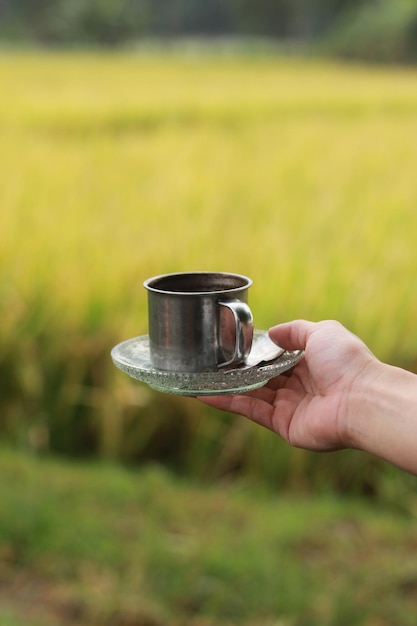 Close-up of hand holding coffee cup