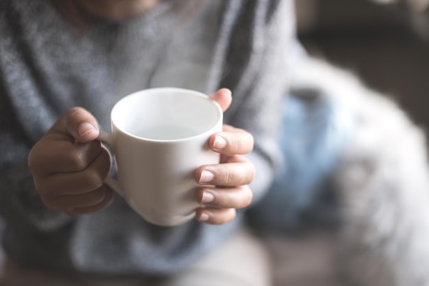 close-up of hand holding coffee cup