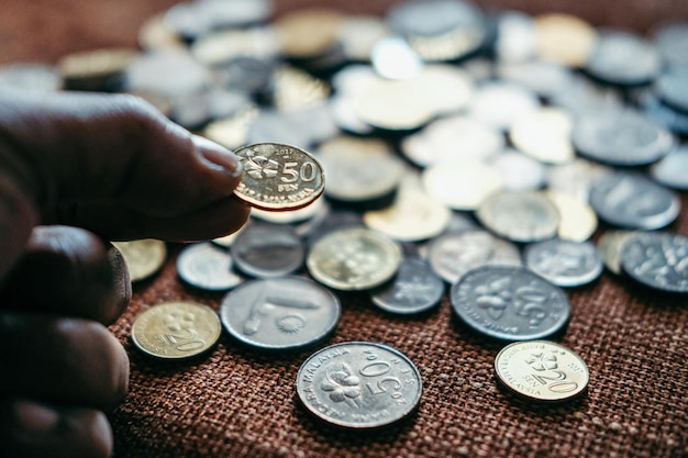 close-up of hand holding coins
