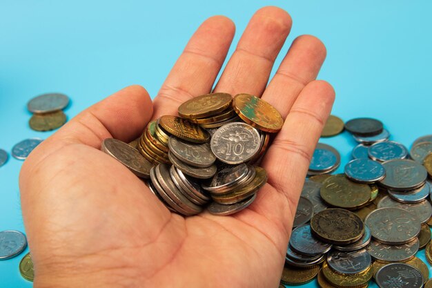 Close-up of hand holding coins