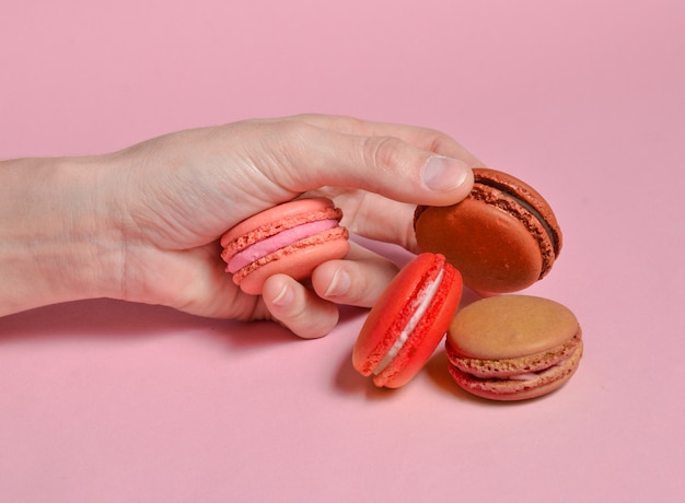 Close up of hand holding colorful macaroons