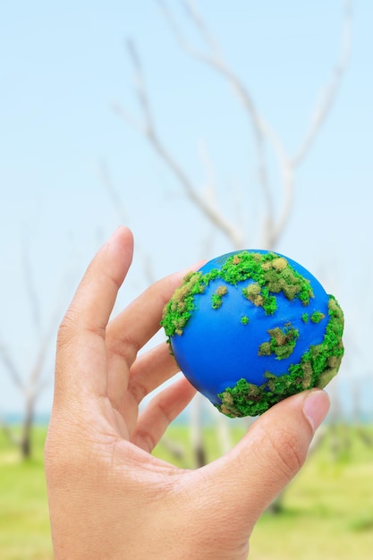 Close-up of hand holding creative sweet food against blue sky