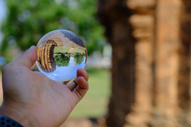 Close-up of hand holding crystal ball