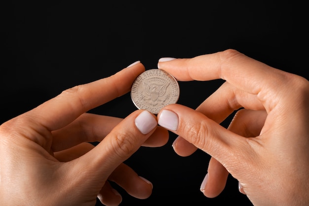 Photo close up on hand holding dollar coin