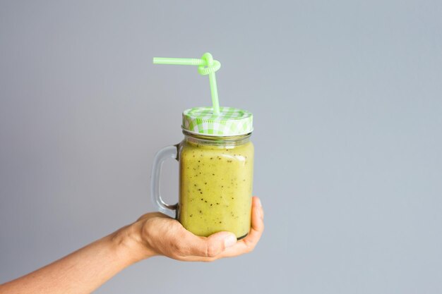 Photo close-up of hand holding drink against white background