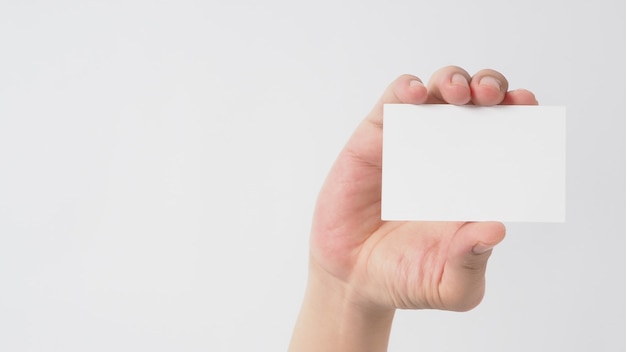 Close up of hand holding empty small card on white background.