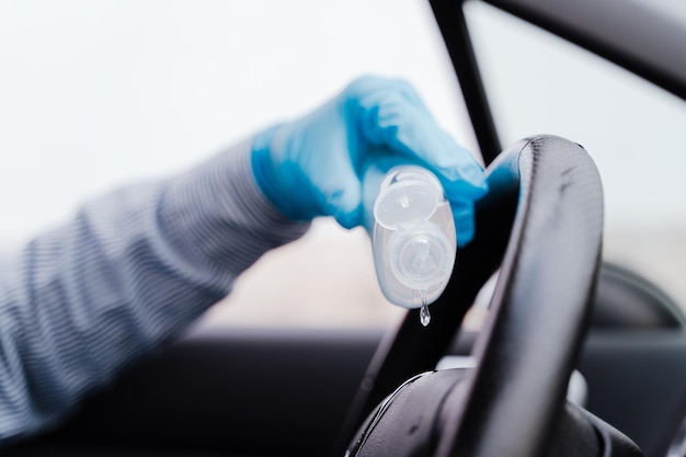 Foto close-up di una mano che tiene gli occhiali su un'auto