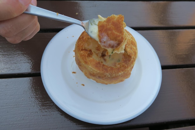 Close-up of hand holding food in plate