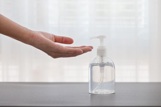 close-up of hand holding glass bottle