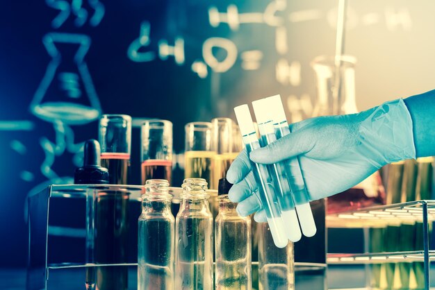 close-up of hand holding glass bottles