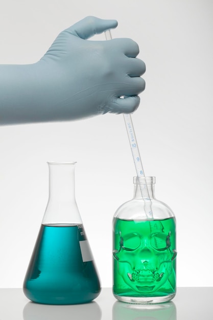 Photo close-up of hand holding glass over white background