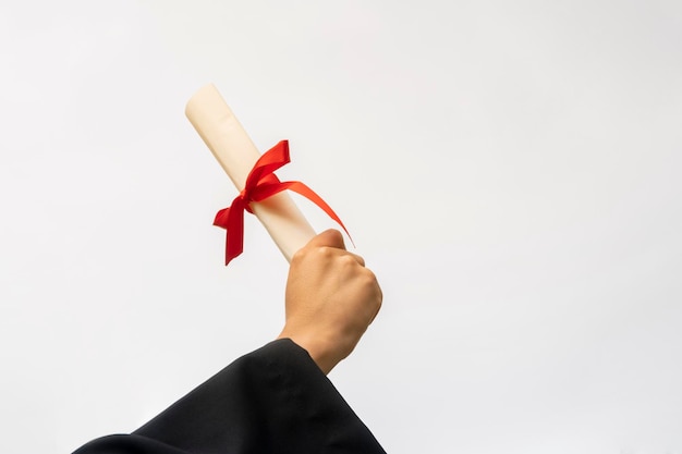 Photo close up hand holding a graduation degree