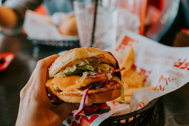 Close-up of hand holding a hamburger ready to eat