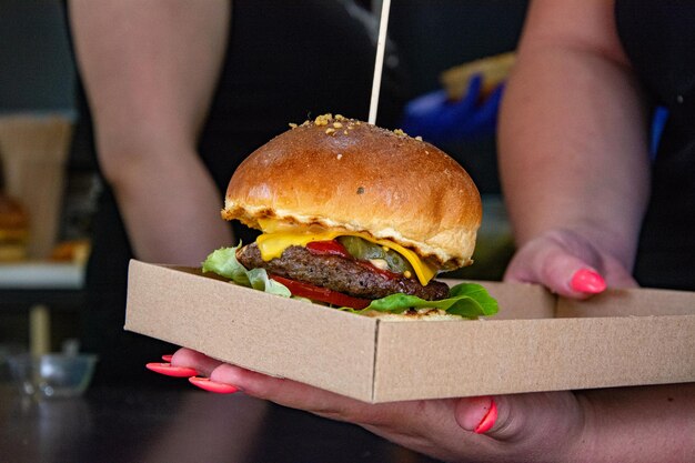 Close-up of hand holding hamburger