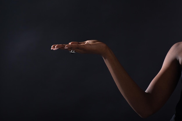 Photo close-up of hand holding hands against black background