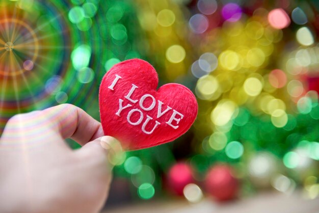 Photo close-up of hand holding heart shape with text