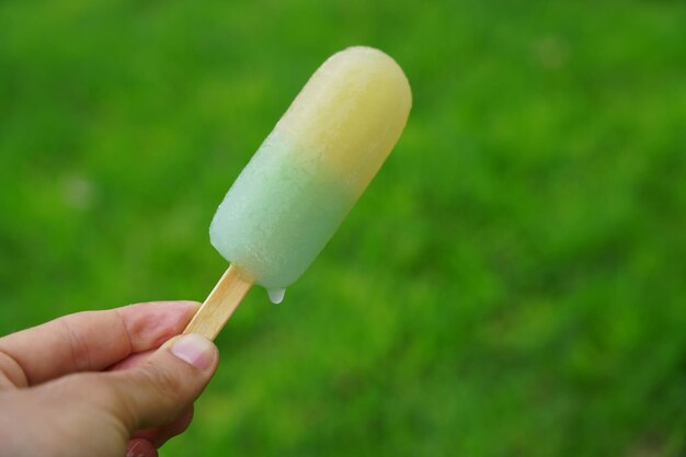 Close-up of hand holding ice cream