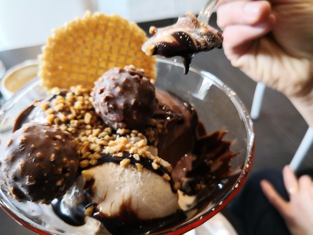 Photo close-up of hand holding ice cream