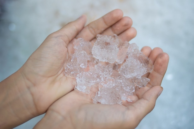 close up hand holding ice cube