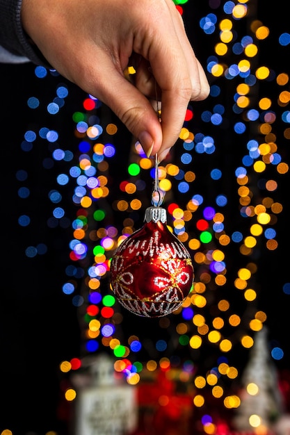 Close-up of hand holding illuminated christmas lights